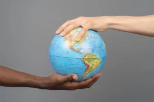 Two people holding a globe
