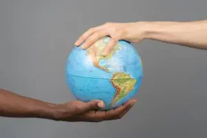 Two people holding a globe